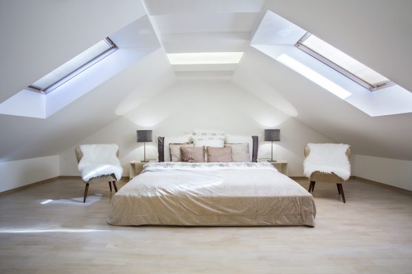 Bright attic bedroom in the fashionable apartment